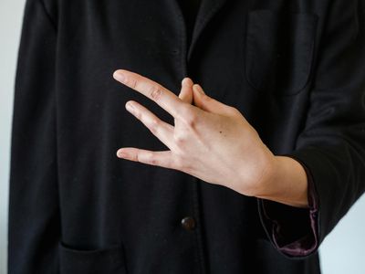 Close up of a person's hands in mudra position.