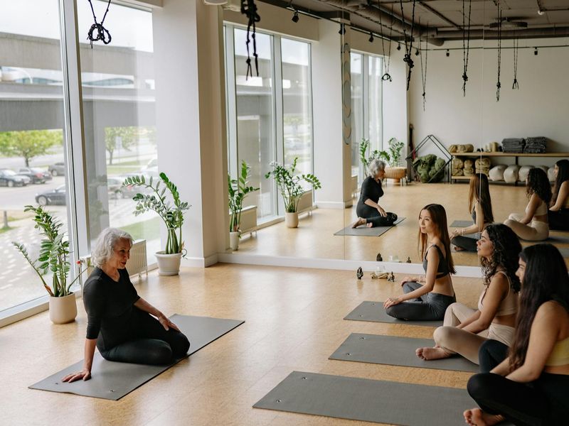 Wide angle view of a peaceful yoga studio interior.
